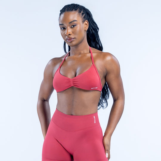 Red strappy triangle sports bra with ruched center and thin adjustable straps