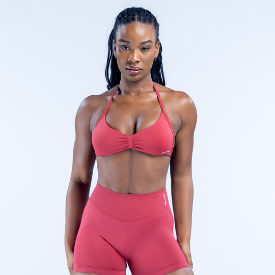 Red strappy triangle sports bra with center ruching and V neckline