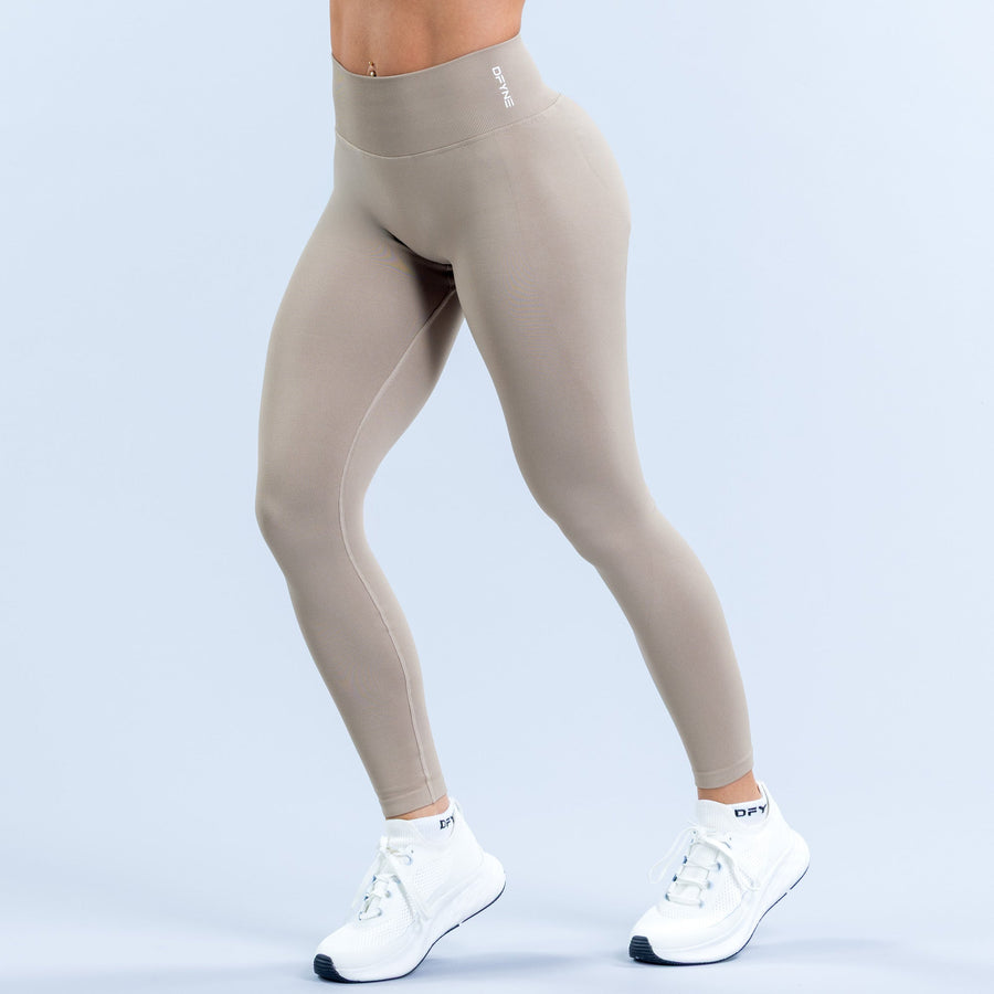 Women's light taupe leggings with waistband logo and full-length fit