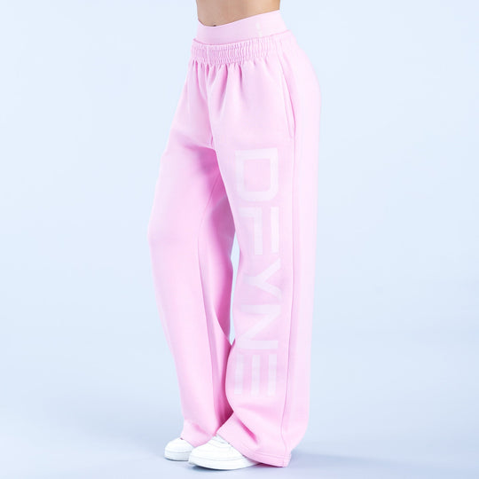 Pink wide-leg jogger pants with elastic waistband and large vertical logo graphic on leg.