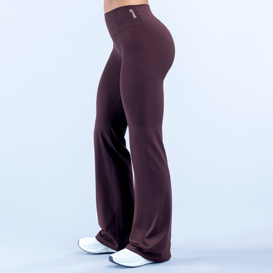 Burgundy high-waist flare pants with logo label on waistband and draped wide legs