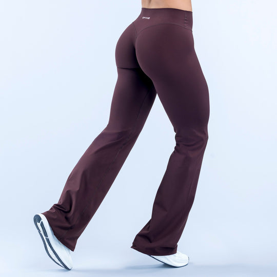 Burgundy flare leggings with smooth wide legs and small side logo near waistband