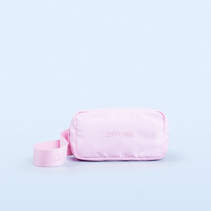 Pink crossbody bag with front logo, zipper top, and adjustable webbing strap