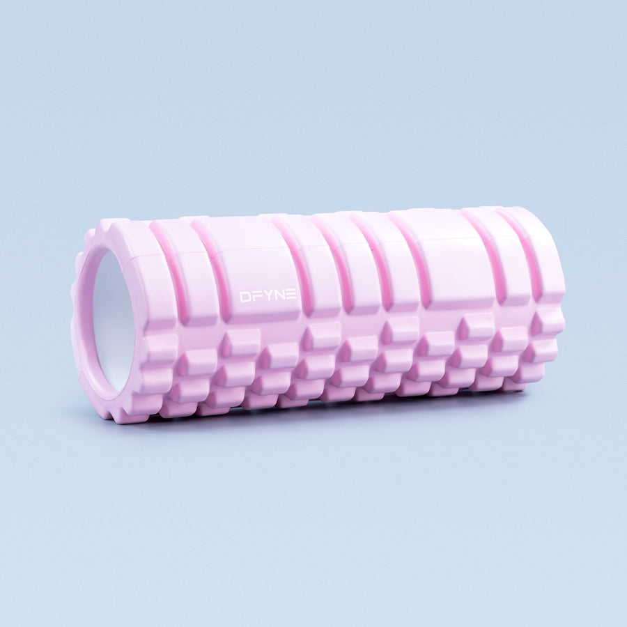 Pink foam roller with hollow core and ridged surface texture, DRYNE logo