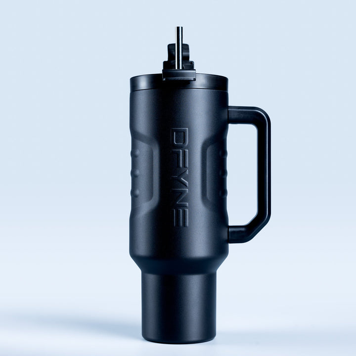 Insulated black drink tumbler with handle and straw, side view