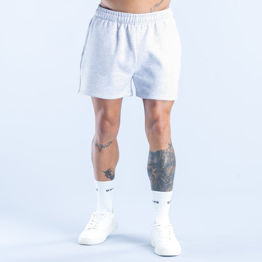 Light heather blue shorts with elastic waistband, above-knee length, standing view