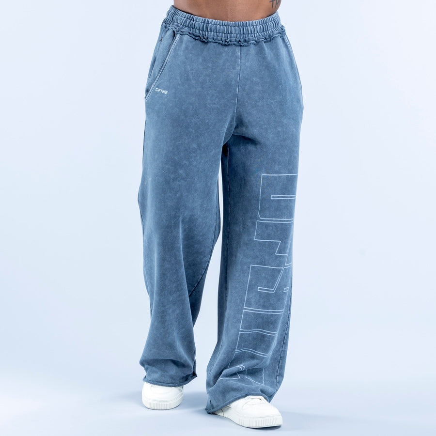 Washed jogger pants in blue wash with elastic waistband and large vertical line-art graphic
