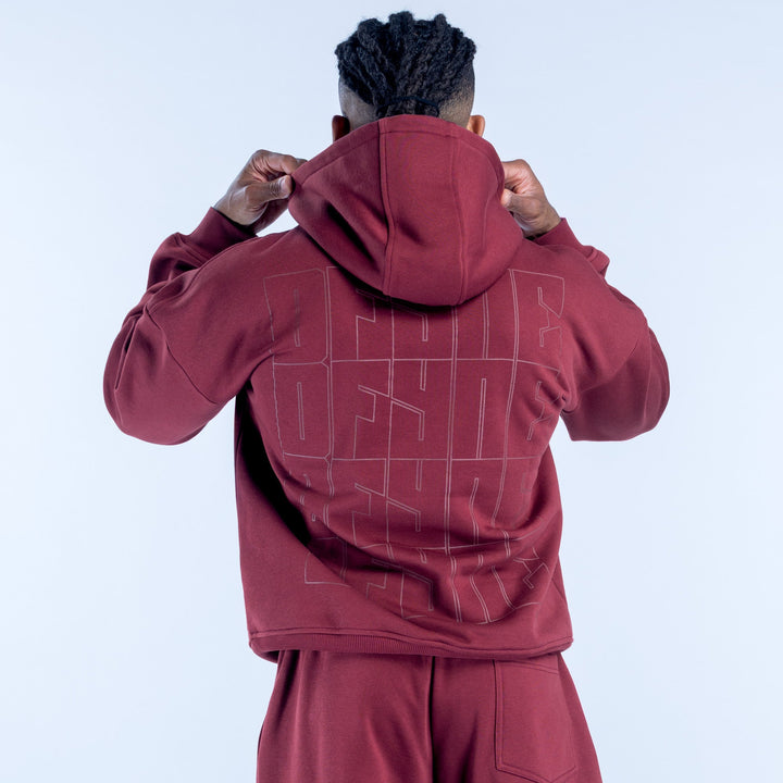 Burgundy graphic hoodie with hood and back print, shown from behind