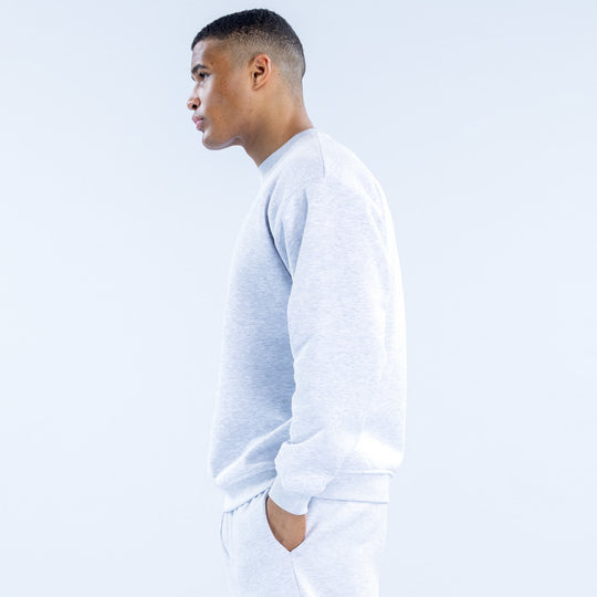 Light heather gray crewneck sweatshirt, side view with long sleeves and ribbed cuffs