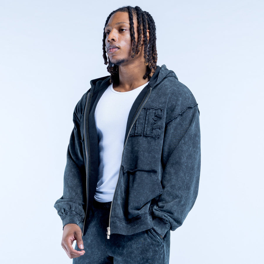 Dark gray washed zip hoodie with hood, flap pockets, and chest logo lettering