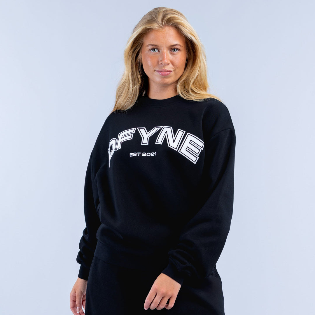 Black crewneck graphic sweatshirt with OFYNE logo and EST 2021 print
