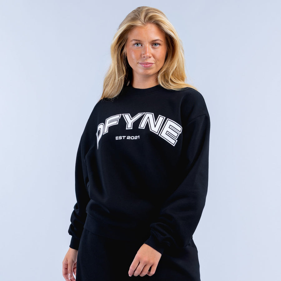 Black crewneck graphic sweatshirt with OFYNE logo and EST 2021 print