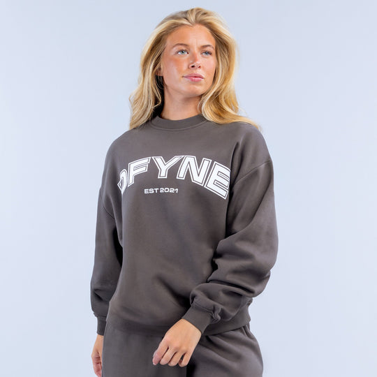Dark gray crewneck sweatshirt with large front graphic and ribbed cuffs