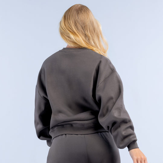 Dark gray sweatshirt back view with ribbed crew cuffs and straight hem