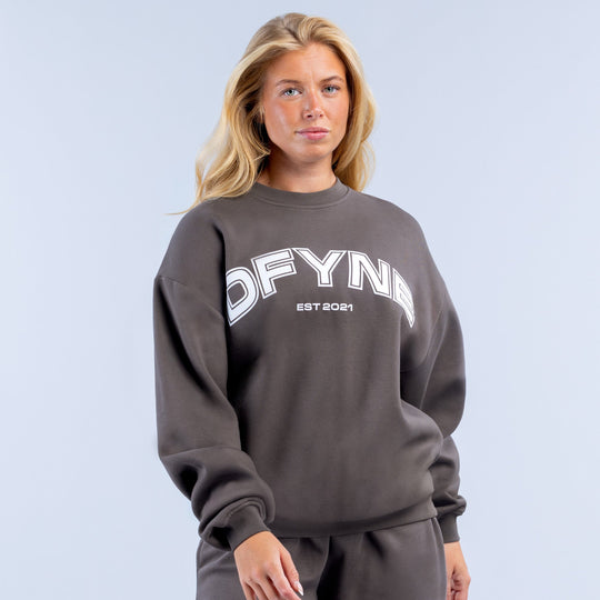 Dark gray crewneck sweatshirt with bold DFYNE EST 2021 front graphic