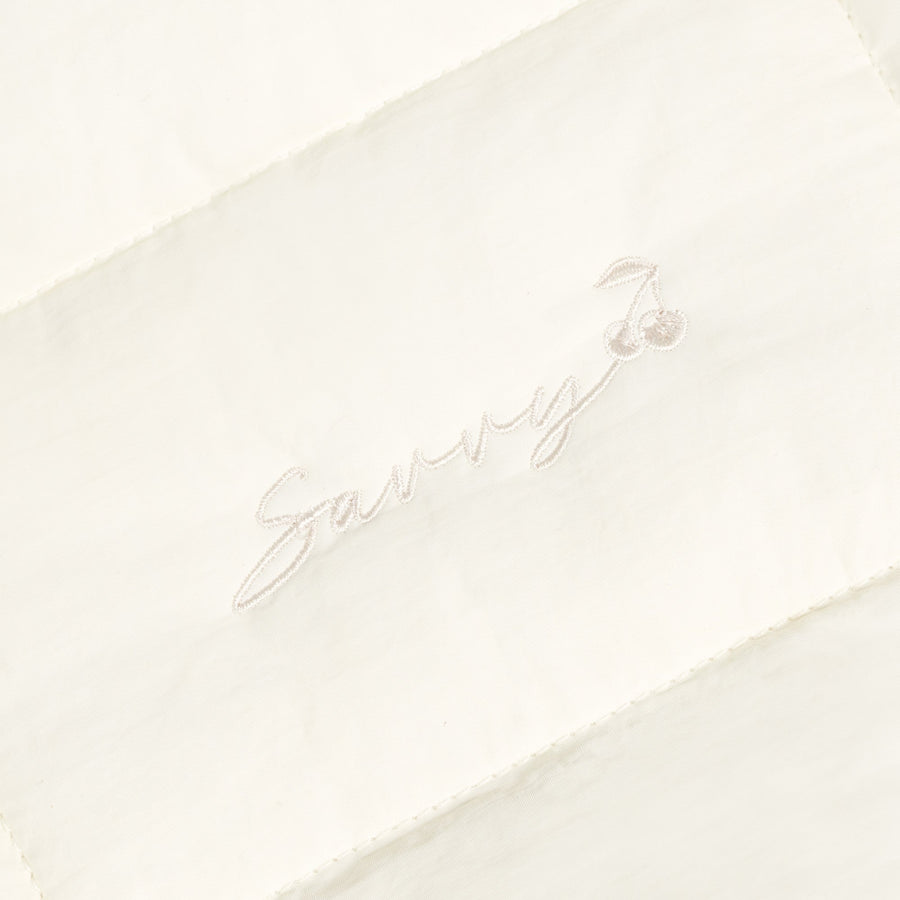 Sav puffer bag with embroidered 'Sav' script logo on ivory fabric