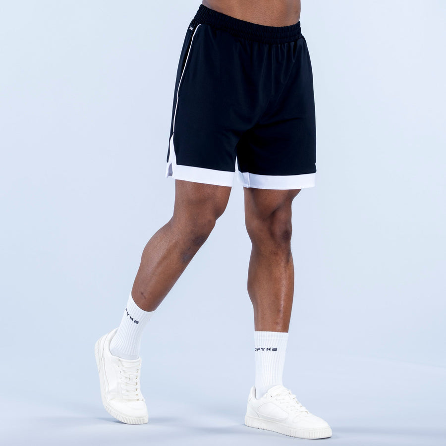 Dark jersey shorts with elastic waist and white-trim hem; knee-length fit