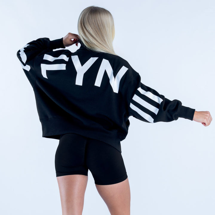 Black quarter-zip sweatshirt with large back lettering and striped sleeve cuffs