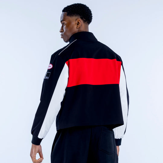 Black track jacket back with bold red center stripe, white side panels, zip front, stand collar
