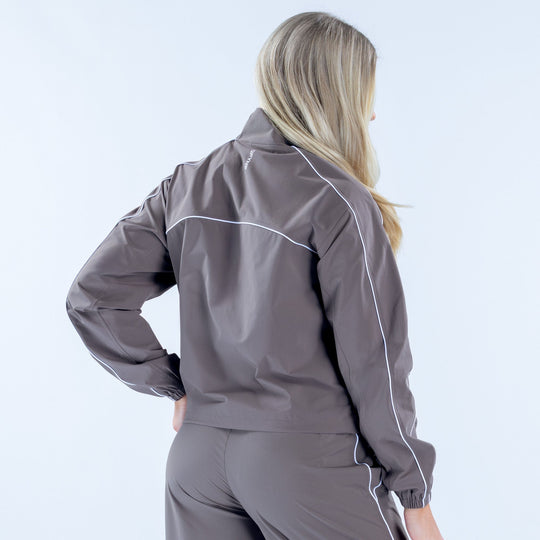 Women's gray track jacket back view, full-zip with white piping and elastic cuffs