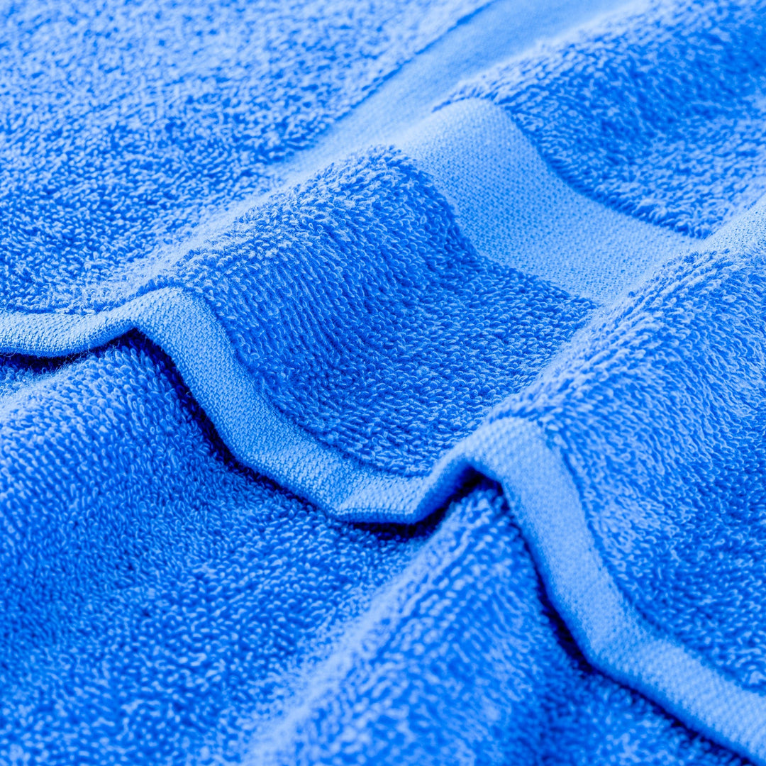 Blue terry gym towel with textured loop fabric and stitched edge close-up