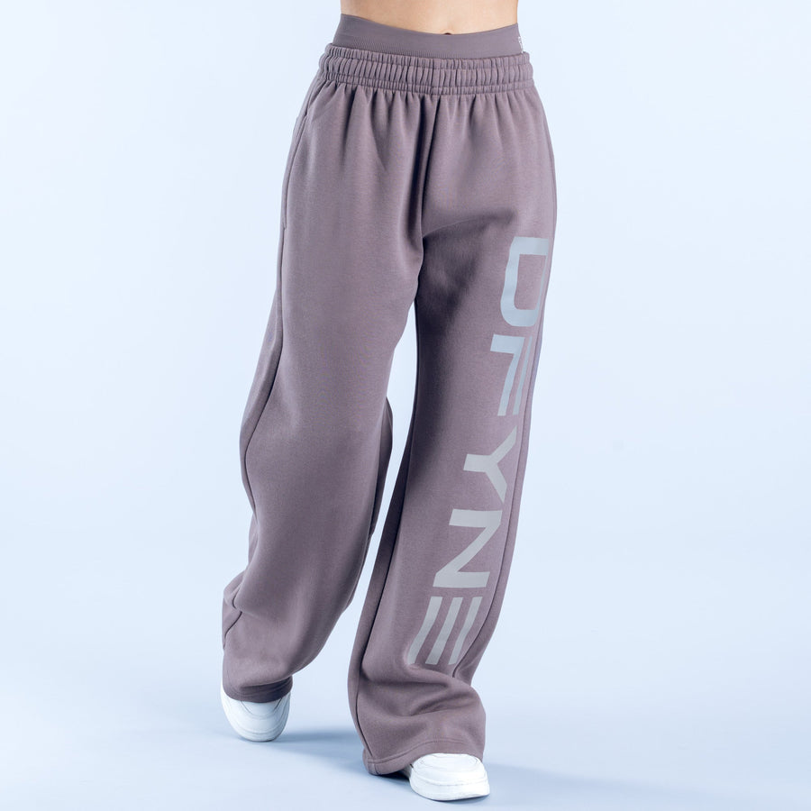 Taupe wide-leg joggers with elastic waist and vertical 'DENY' logo graphic