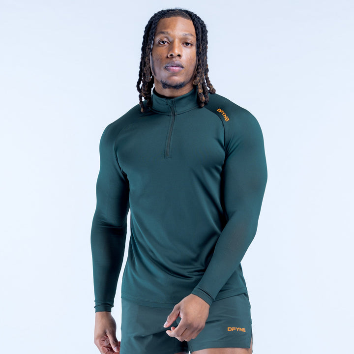 Teal long-sleeve quarter-zip athletic top with half-zip collar