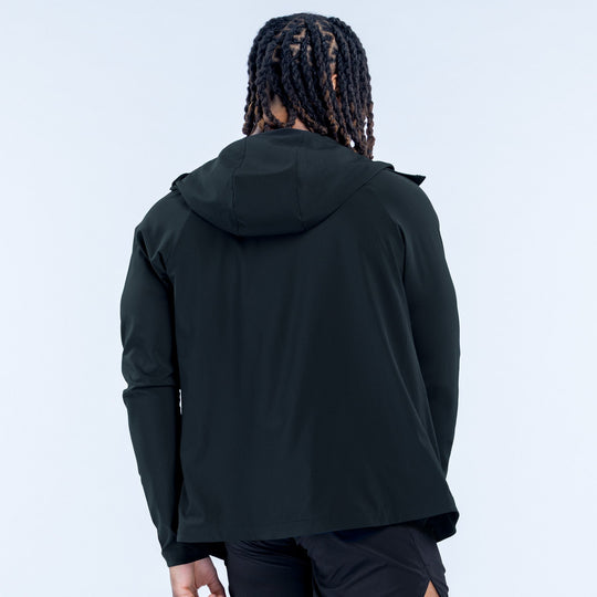 Back view of Unbound jacket, dark hooded windbreaker with zip front