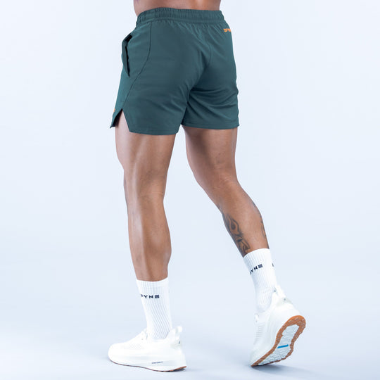 Men's teal training shorts with cargo-style side pocket, elastic waistband