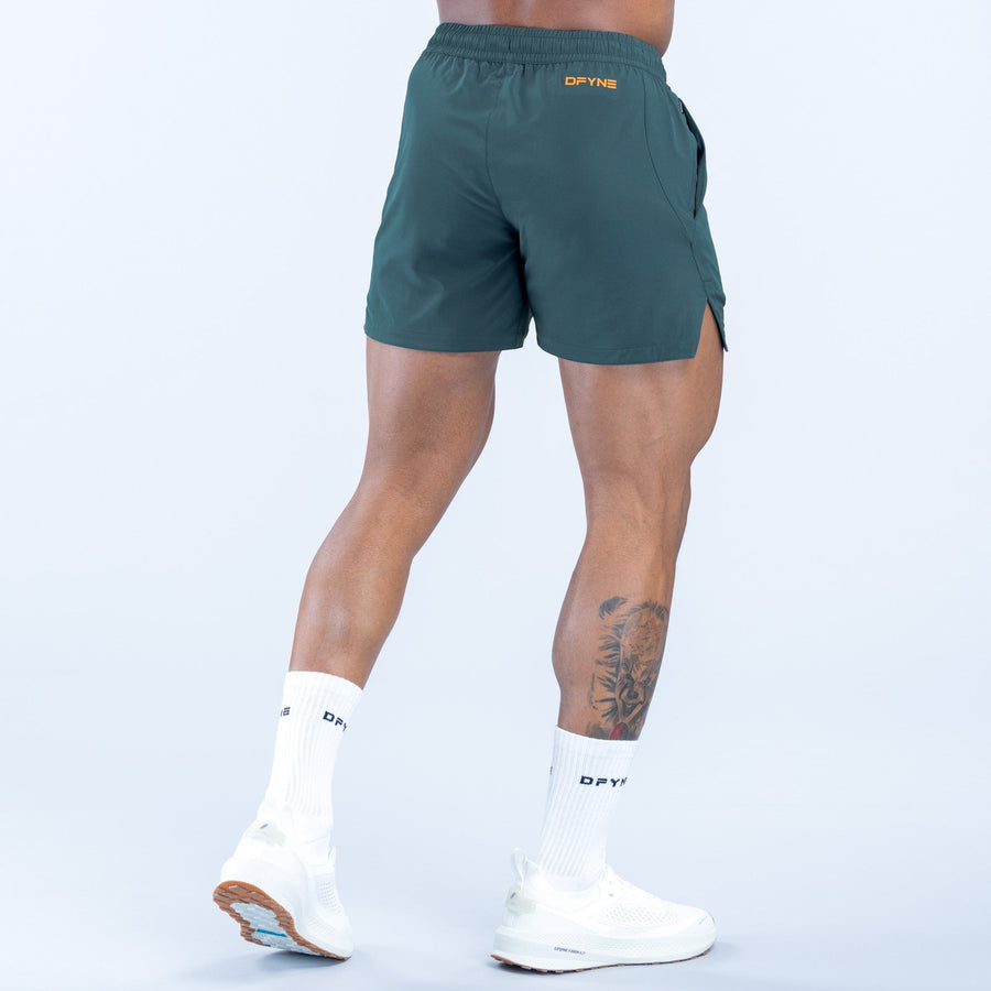 Men's teal training shorts, back view, elastic waist, rear pocket