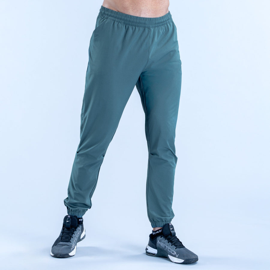 Teal training jogger pants, front view, elastic waist with cuffed ankle hems