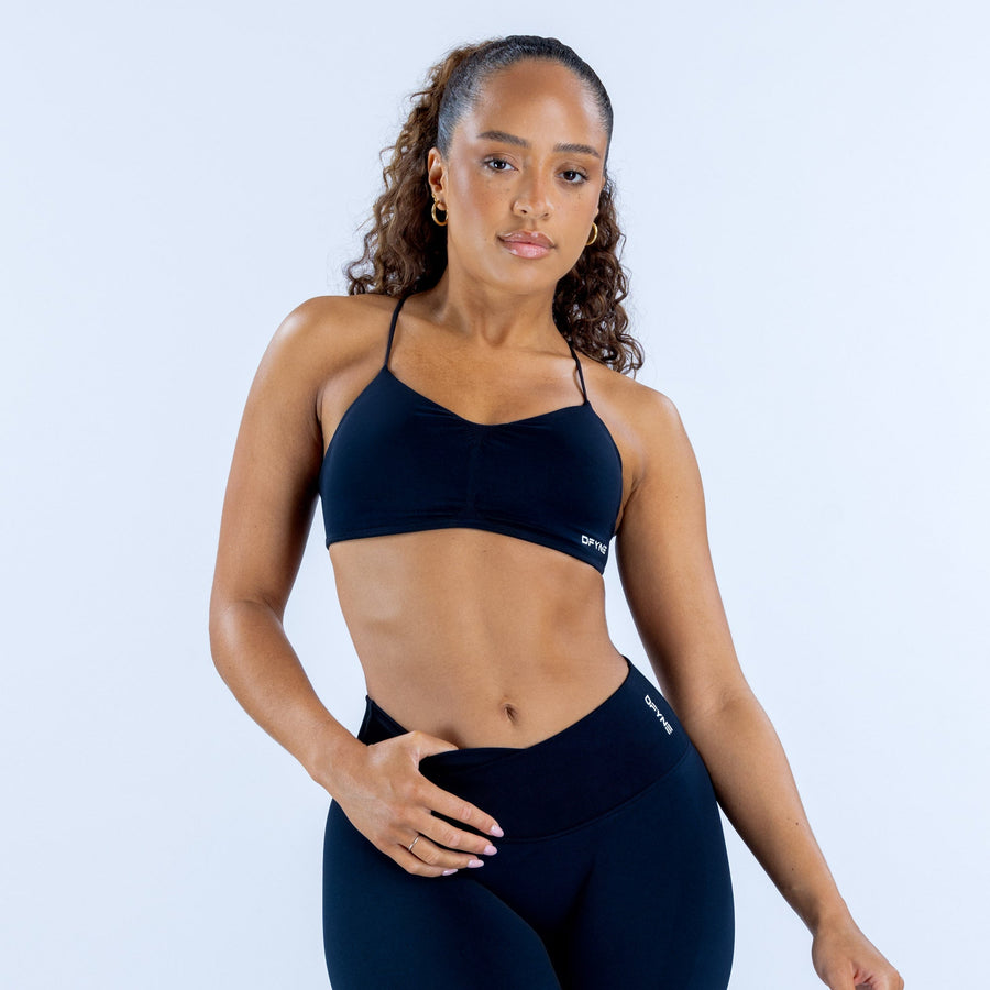 Navy supportive sports bra with thin straps, curved underband and small logo