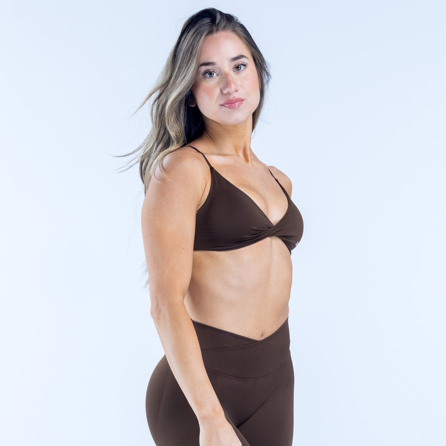 Dark brown twist-front sports bra with thin straps and DFYN logo band