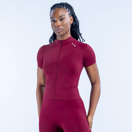 Burgundy short-sleeve zip-up athletic top with stand collar and full front zipper